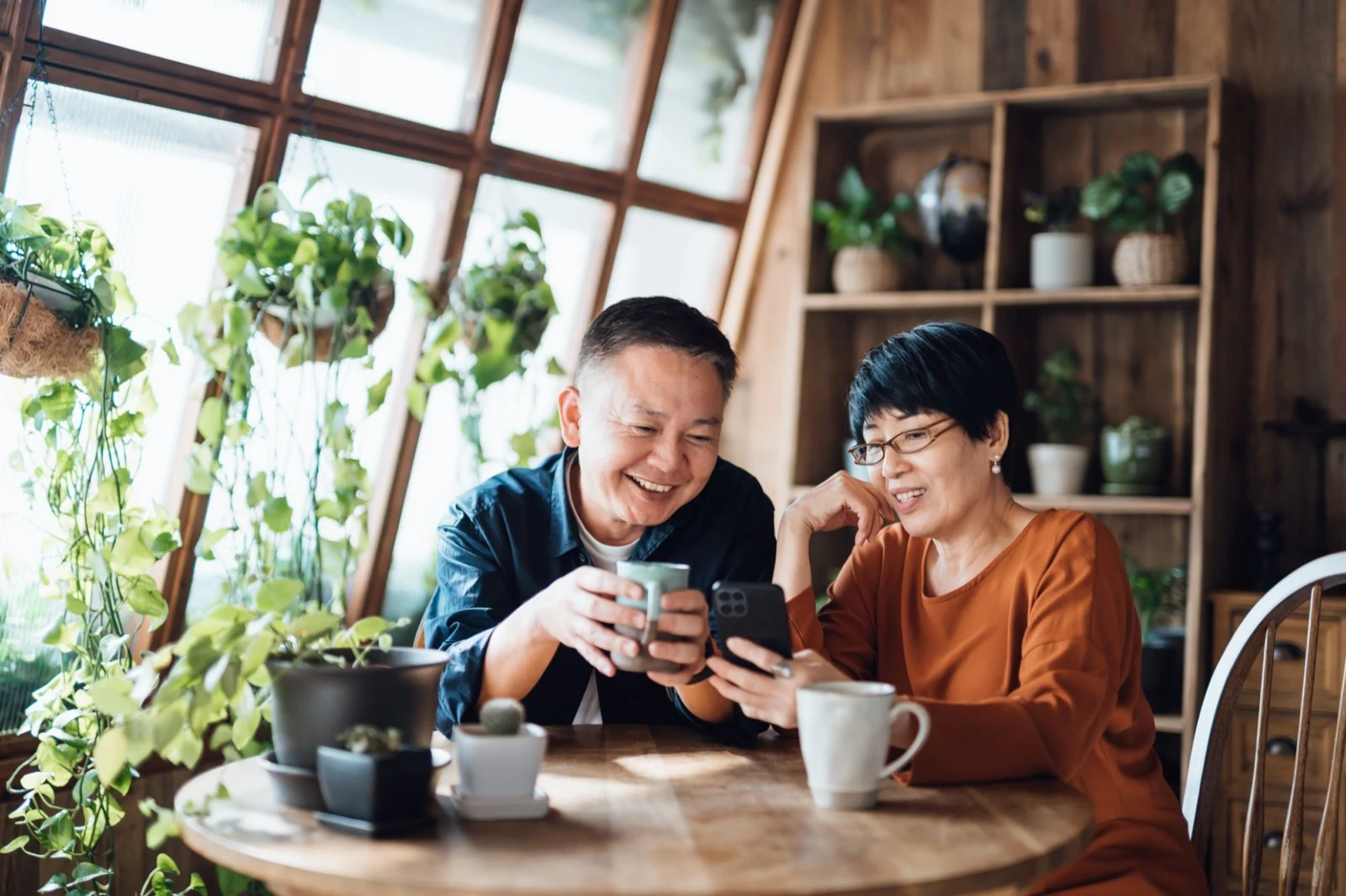 Couple smiling at a phone together at home