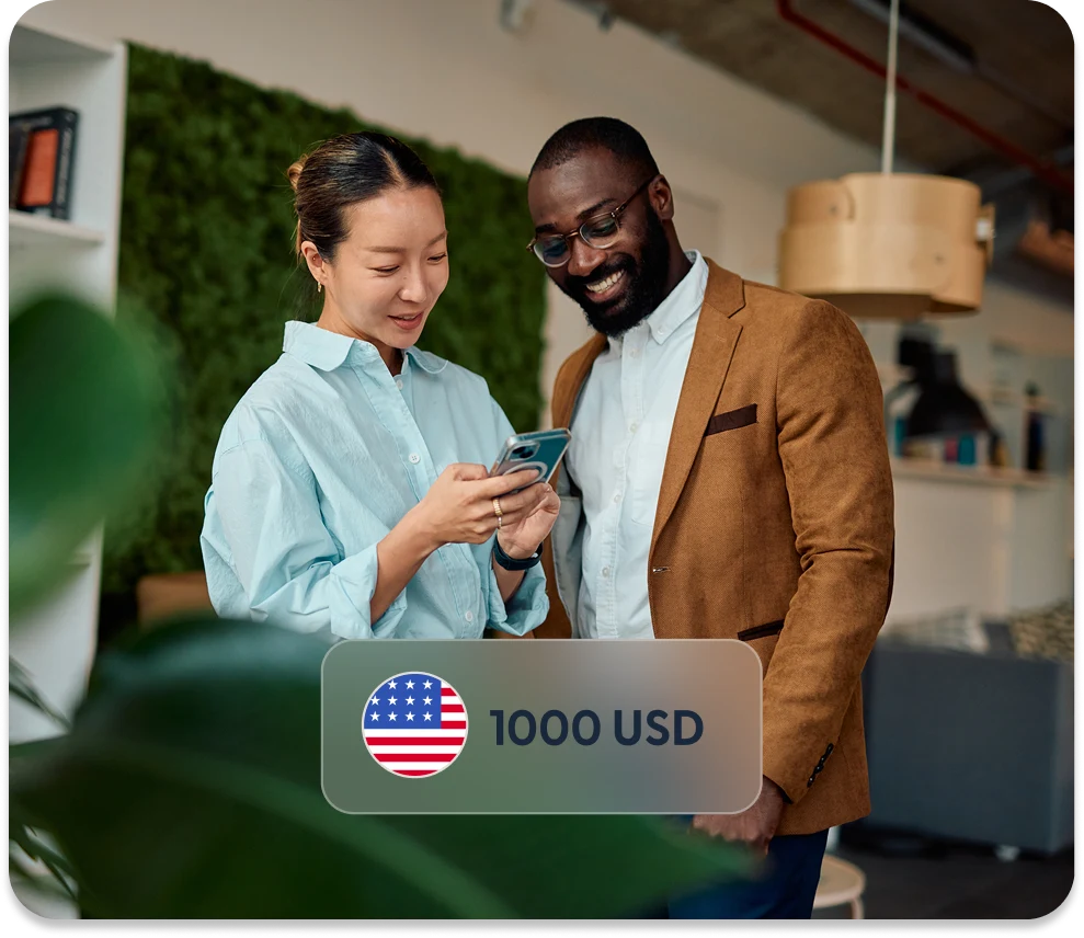Two colleagues reviewing a payment on a phone