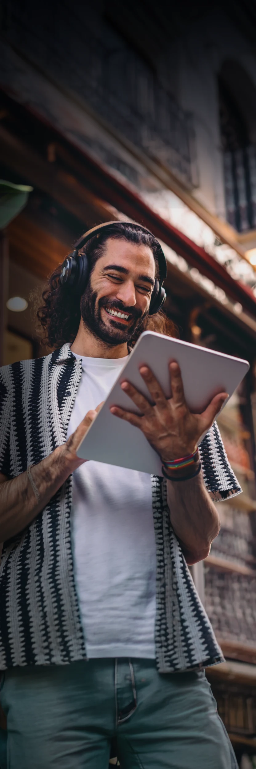 Business owner in headphones holding a tablet