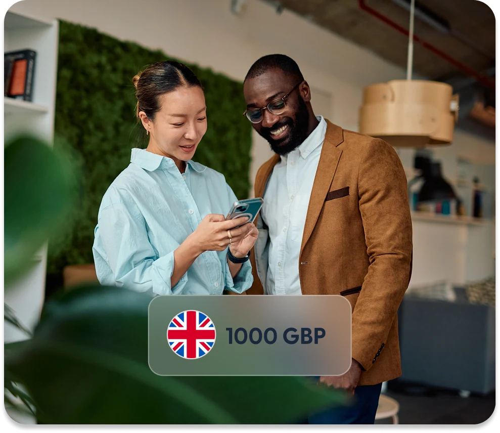 Two colleagues reviewing a payment on a phone