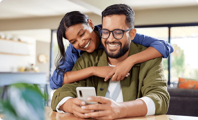 Two people looking at a phone together.