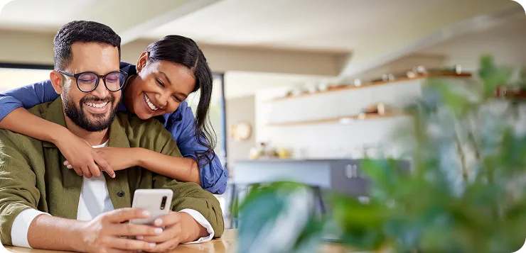 Two people looking at a phone together.